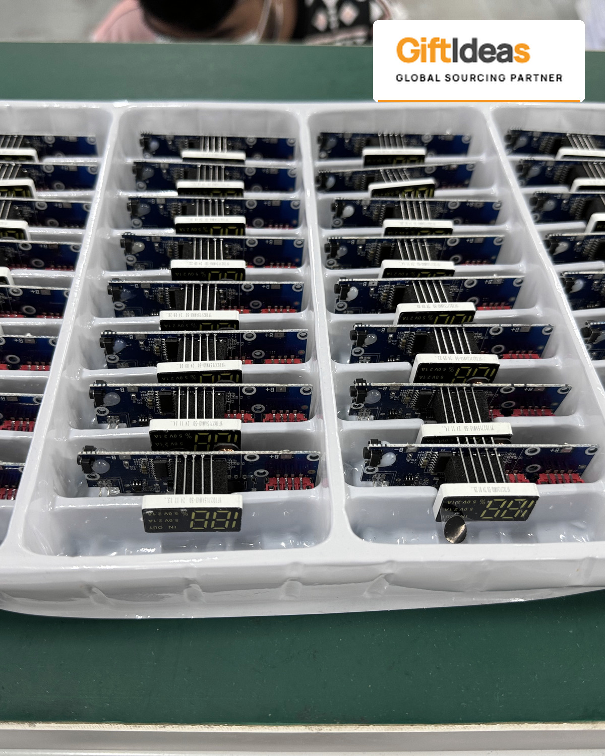 Electronic components arranged in individual tray compartments